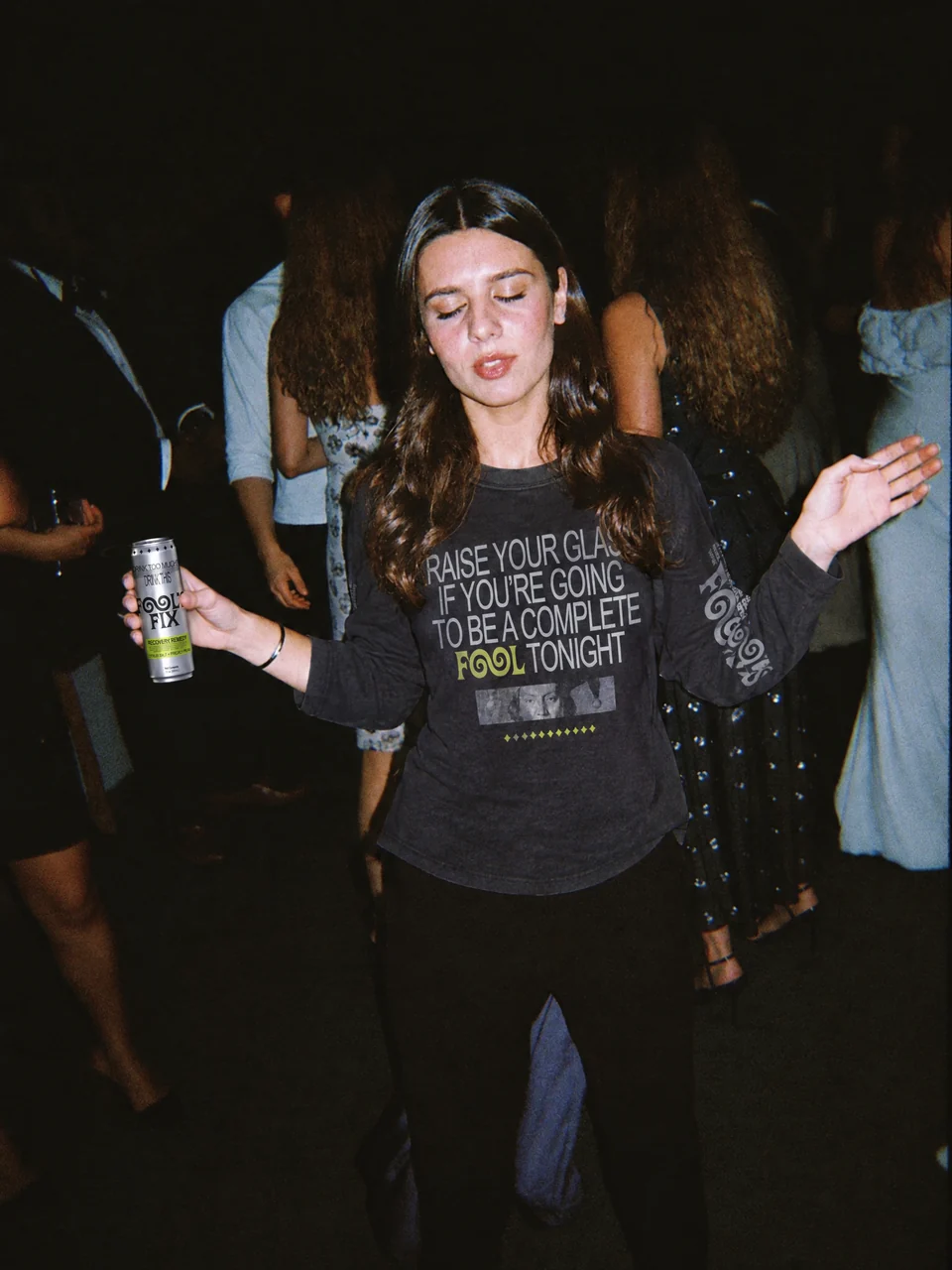 Laura dancing on a night out holding a can of Fool's Fix
