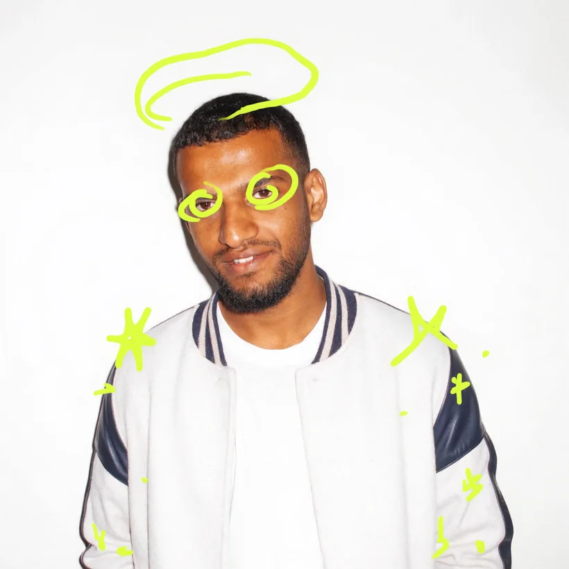 Craig in a varsity jacket against a white wall, with lime doodles of a halo and sparkles