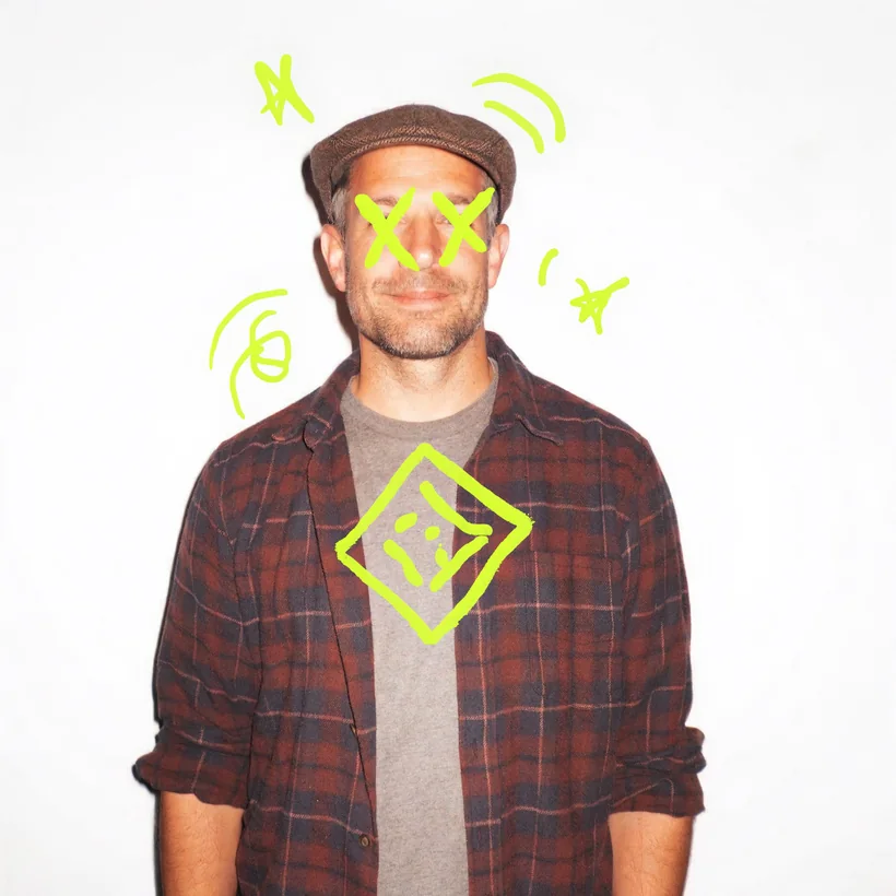 Johnny in a flat cap and checked shirt against a white wall, doodled over in lime